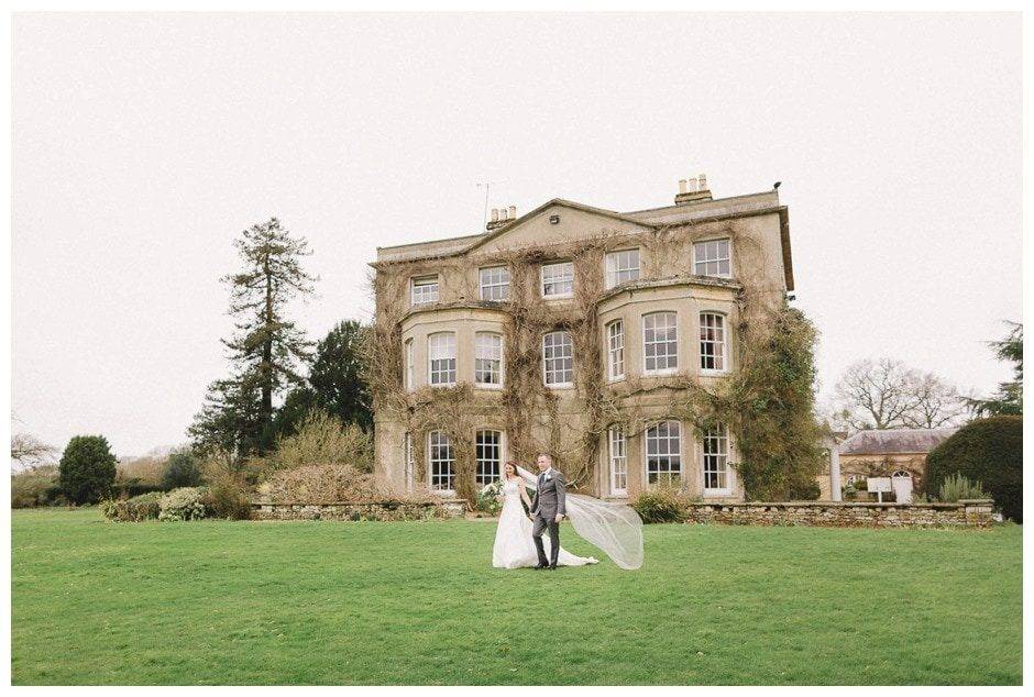 Bride-and-groom-walking-on-lawn